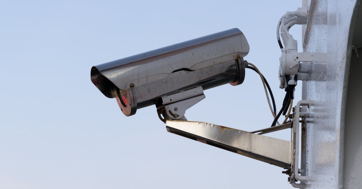 Close-up of an outdoor CCTV camera installed on a wall for security purposes.